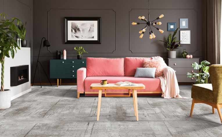 grey patterned carpet in eclectic living room with pink couch